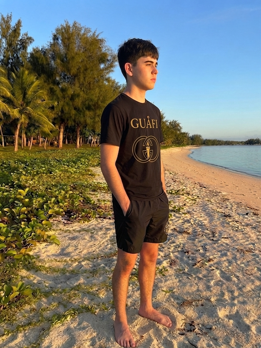 Black adult tee with gold Guafi logo, flat lay
