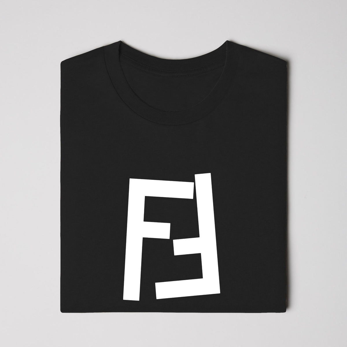 Black adult tee with white Fotte logo, worn